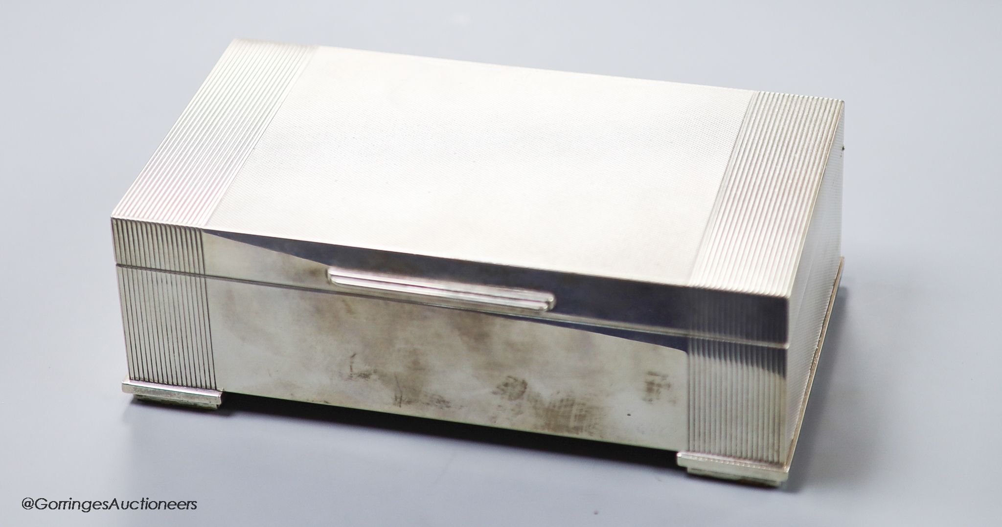 An engine-turned silver rectangular cigarette box, by Garrard & Co Ltd,